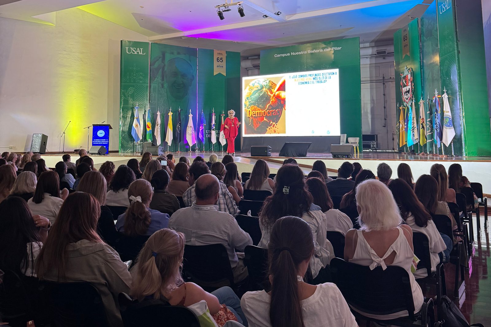 Auditorio colmado durante el XXII Congreso de Educación, con la pantalla y las banderas del escenario al fondo